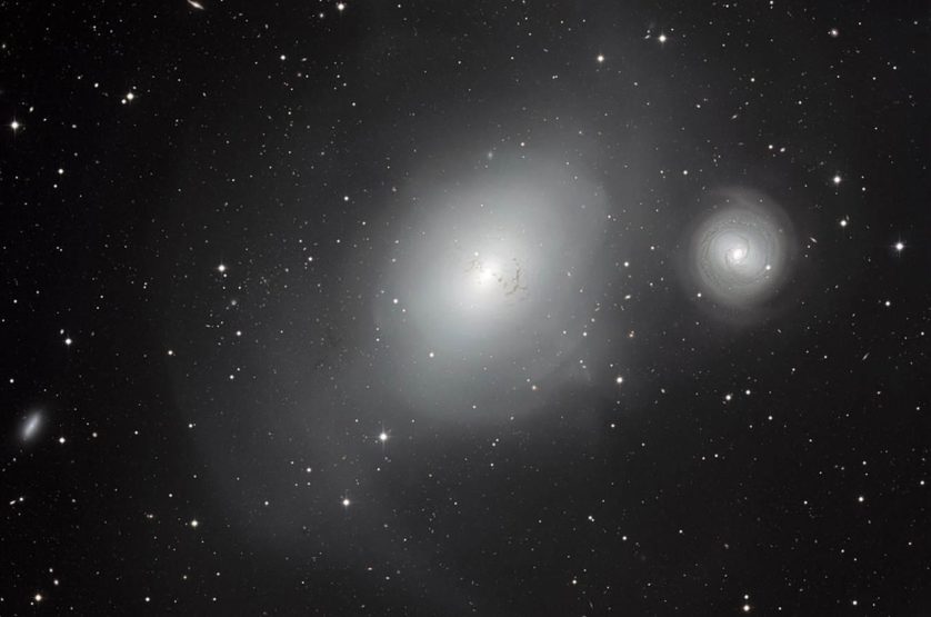 Esta imagem do Observatório La Silla, no Chile, mostra um par contrastante de galáxias: a NGC 1316 e sua companheira menor NGC 1317 (à direita). Embora a NGC 1317 parece ter tido uma existência pacífica, sua vizinha maior carrega cicatrizes de fusões anteriores com outras galáxias.  