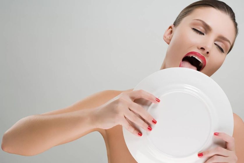 Woman licking a plate