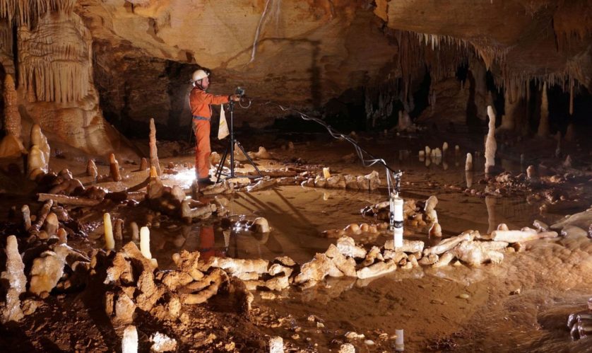 A scientist takes measurements for the archaeo-magnetic survey in the Bruniquel Cave in southwestern France in this undated handout photo